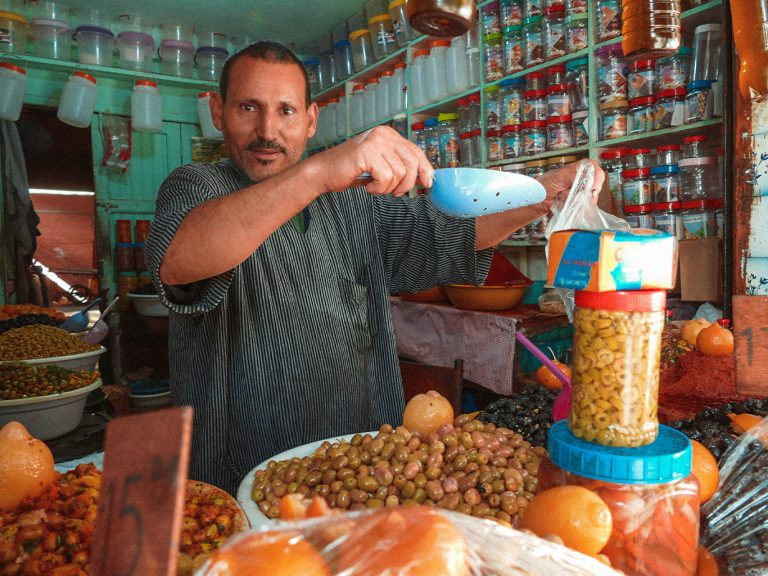 Ein Obstverkäufer in der Medina in der Königsstadt Fès füllt Trockenfrüchte ab