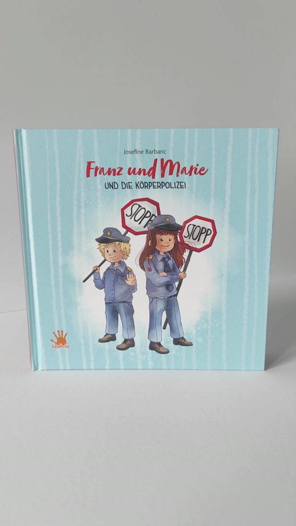 Das Kinderbuch "Franz und Marie und die Körperpolizei" vor einem grauen Hintergrund