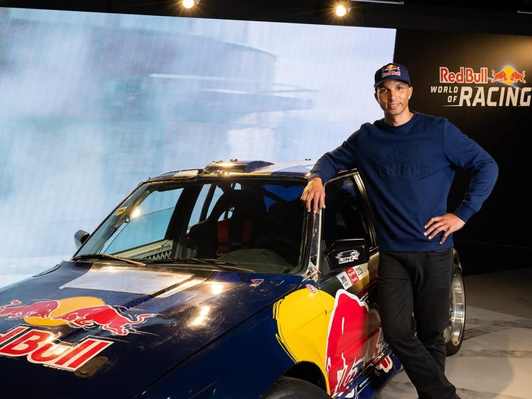 Elias Hountondji steht lässig vor einem Wagen der Red Bull Driftbrothers