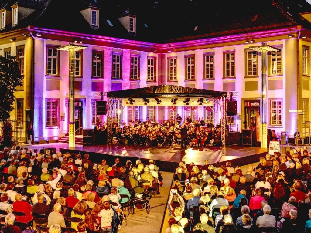 Abendliches Open-Air-Konzert auf dem Göppinger Marktplatz vor dem illuminierten Rathaus mit Publikum und Orchester beim Tag der Musik in Göppingen