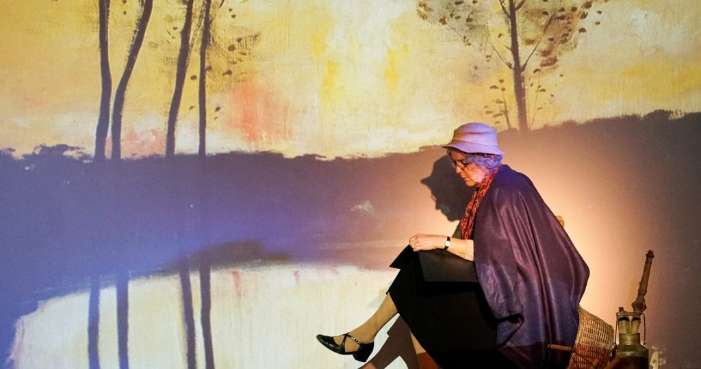 Schauspielerin im Bühnenlicht vor gemaltem Hintergrund – poetische Hommage „Ein Lied aus Stille“ an Eva Strittmatter im Nachmittagstheater Süßen.