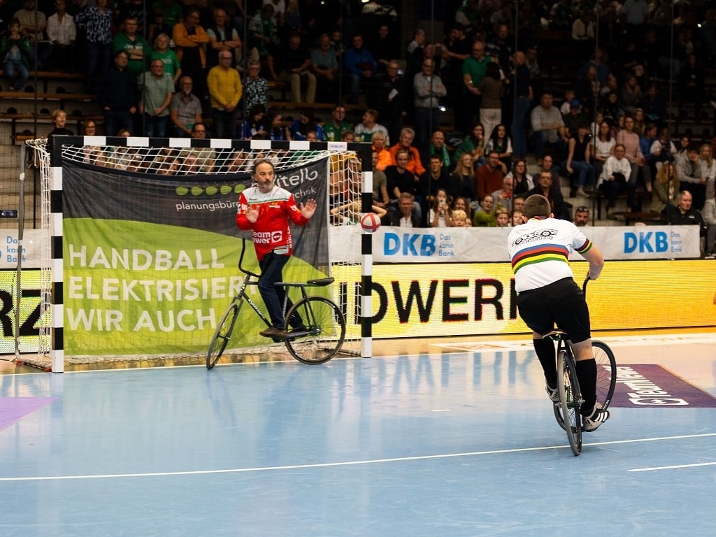 Radballspieler im Zweikampf während der Hallenrad WM Göppingen 2025 in der EWS Arena vor jubelndem Publikum